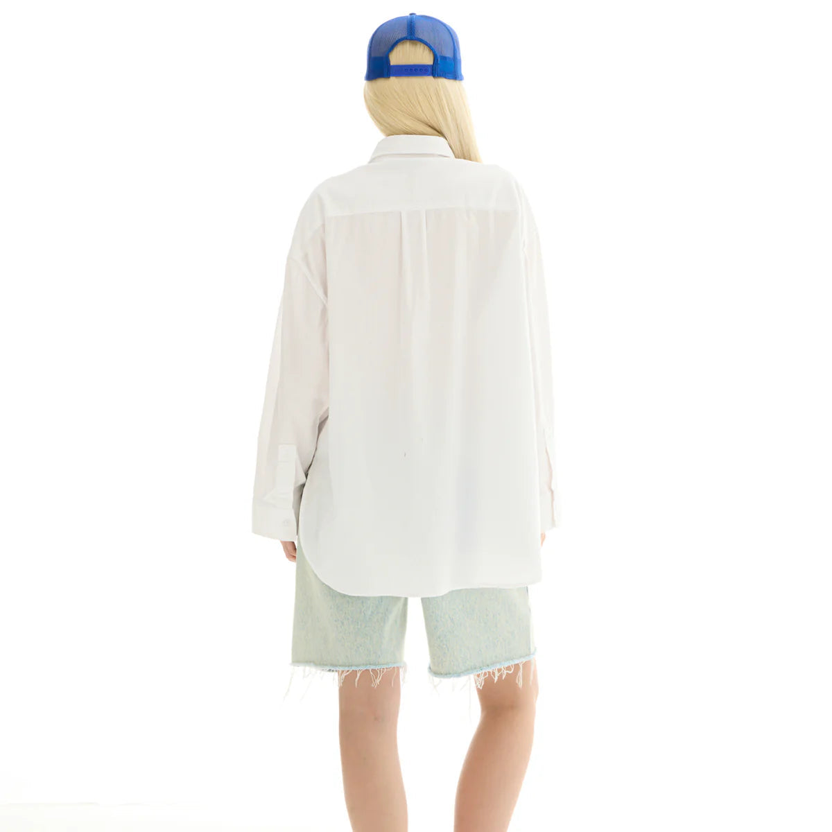 Person wearing a white shirt, light green shorts, and a blue cap on a white background